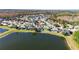 Aerial view of the backyard features a pool, beautiful landscaping, and a view of the lake at 10642 Cloudview Dr, Orlando, FL 32825
