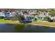 Back view of home features a beautiful lake view, a white fence, and a lawn at 10642 Cloudview Dr, Orlando, FL 32825