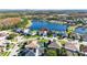 Aerial view of lakefront property in a desirable community with mature trees at 10642 Cloudview Dr, Orlando, FL 32825