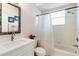 Bright bathroom featuring a single sink vanity, and shower-tub combo at 10642 Cloudview Dr, Orlando, FL 32825