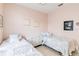 Comfortable bedroom featuring two twin beds, dresser and neutral decor at 10642 Cloudview Dr, Orlando, FL 32825