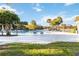 Relaxing community pool area with clear blue water, lounge chairs, and serene lake views for residents' enjoyment at 10642 Cloudview Dr, Orlando, FL 32825