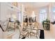 Bright dining room with a large mirror reflecting a glass dining table and elegant decor at 10642 Cloudview Dr, Orlando, FL 32825