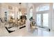 Formal dining room featuring chandelier lighting and elegant decor adjacent to foyer at 10642 Cloudview Dr, Orlando, FL 32825