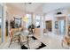 Spacious dining area with a glass table set, complemented by large windows and neutral decor at 10642 Cloudview Dr, Orlando, FL 32825