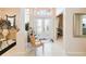 Elegant foyer featuring tile flooring, decorative columns, and ornate glass double doors at 10642 Cloudview Dr, Orlando, FL 32825