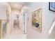Hallway with art decorations and access to bath with shower tub combination at 10642 Cloudview Dr, Orlando, FL 32825