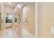 Hallway with decorative mirror leads to a luxurious bathroom at 10642 Cloudview Dr, Orlando, FL 32825