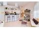 Open kitchen with bar seating, stainless steel appliances, and an adjacent dining area at 10642 Cloudview Dr, Orlando, FL 32825