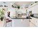 Open kitchen featuring a breakfast bar, white cabinets, and stainless steel appliances at 10642 Cloudview Dr, Orlando, FL 32825