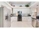 Bright kitchen with white cabinets, stainless steel appliances, and decorative backsplash at 10642 Cloudview Dr, Orlando, FL 32825