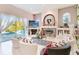 Bright living room with a fireplace, a view of the pool, and comfortable, stylish seating at 10642 Cloudview Dr, Orlando, FL 32825