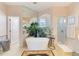 Luxurious main bathroom featuring a soaking tub, walk-in shower, and elegant fixtures at 10642 Cloudview Dr, Orlando, FL 32825