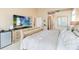 Comfortable main bedroom featuring neutral tones, television, and side table at 10642 Cloudview Dr, Orlando, FL 32825