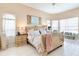 Bright main bedroom with a ceiling fan, large windows, and comfortable seating area at 10642 Cloudview Dr, Orlando, FL 32825