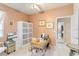 Bright home office with functional furniture, natural light, and tile flooring at 10642 Cloudview Dr, Orlando, FL 32825