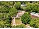 Aerial view of a home with mature trees, in-ground swimming pool and driveway at 112 Brandywine Ln, Longwood, FL 32779