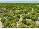 An aerial view showcases this home surrounded by verdant trees and a large neighborhood at 112 Brandywine Ln, Longwood, FL 32779