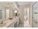 Bathroom with a long vanity, tiled floors, and a toilet in a separate alcove at 112 Brandywine Ln, Longwood, FL 32779