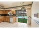 Efficient kitchen layout with wood cabinets, a view of the pool, and tile floors for a functional cooking space at 112 Brandywine Ln, Longwood, FL 32779