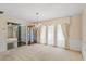 Spacious living area with neutral carpet, chandelier, and classic drapes, offering a versatile and comfortable space at 112 Brandywine Ln, Longwood, FL 32779