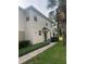 Tan home with small front porch, brick paver walkway, and manicured landscaping at 1122 Priory Cir, Winter Garden, FL 34787