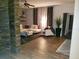 Living room with tile floors, stone accent wall, and white furniture at 1122 Priory Cir, Winter Garden, FL 34787