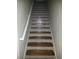Stairway with decorative tile risers and a white handrail offers a unique design element at 1122 Priory Cir, Winter Garden, FL 34787
