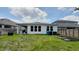 The home's backyard has a covered patio area and ample green space for outdoor activities at 14741 Milfoil Ave, Orlando, FL 32827
