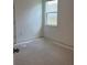 Bright bedroom with large window and neutral walls at 14741 Milfoil Ave, Orlando, FL 32827