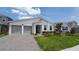 Charming single-story home with a two-car garage, manicured lawn, and modern architectural style at 14741 Milfoil Ave, Orlando, FL 32827