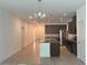 Open kitchen featuring granite countertops, stainless steel appliances, and tile flooring at 14741 Milfoil Ave, Orlando, FL 32827