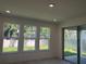 Living room featuring large windows and sliding glass doors to the backyard at 14741 Milfoil Ave, Orlando, FL 32827