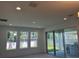 Living room featuring large windows and sliding glass doors to the backyard at 14741 Milfoil Ave, Orlando, FL 32827