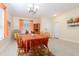 Bright dining area with tile flooring and views to the foyer and large windows at 14741 Sapodilla Dr, Orlando, FL 32828