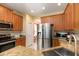 Modern kitchen featuring stainless steel appliances, granite counters, and beautiful wood cabinets at 14741 Sapodilla Dr, Orlando, FL 32828