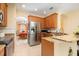 Contemporary kitchen featuring stainless steel appliances, granite countertops, and natural wood cabinets at 14741 Sapodilla Dr, Orlando, FL 32828