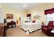 Bedroom with a cozy sitting area, desk, and soft carpet for a relaxing retreat at 14741 Sapodilla Dr, Orlando, FL 32828