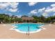 Community pool surrounded by lounge chairs and tropical landscaping on a bright sunny day at 14741 Sapodilla Dr, Orlando, FL 32828