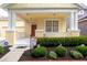 Inviting front porch with white columns, patriotic decorations, and well-maintained landscaping at 14741 Sapodilla Dr, Orlando, FL 32828