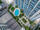 Aerial view of a luxury high-rise community with a pool, landscaping, and modern design at 155 S Court Ave # 2008, Orlando, FL 32801