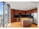 Modern kitchen with island, wooden cabinets, black backsplash and stainless steel appliances at 155 S Court Ave # 2008, Orlando, FL 32801
