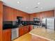 Modern kitchen with stainless steel appliances, dark backsplash and granite countertops at 155 S Court Ave # 2008, Orlando, FL 32801