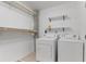 Functional laundry room with a washer, dryer, shelving, and clothes hanging bar at 155 S Court Ave # 2008, Orlando, FL 32801