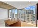 Open floor plan features a kitchen island adjacent to a wall of windows and cityscape views at 155 S Court Ave # 2008, Orlando, FL 32801
