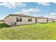 Spacious backyard with lush green grass and view of the neighboring home at 1737 Forest Run Ln, Auburndale, FL 33823