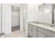 Well-lit bathroom with granite countertop, dual vanity, and walk-in closet access at 1737 Forest Run Ln, Auburndale, FL 33823