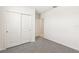 Bedroom featuring neutral carpeting, sliding door closet, and a white trim at 1737 Forest Run Ln, Auburndale, FL 33823