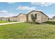 Beautiful home with lush green lawn, landscaping, and attached two-car garage at 1737 Forest Run Ln, Auburndale, FL 33823