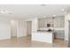 Spacious open-concept kitchen with island, gray cabinets, and stainless steel appliances at 1737 Forest Run Ln, Auburndale, FL 33823